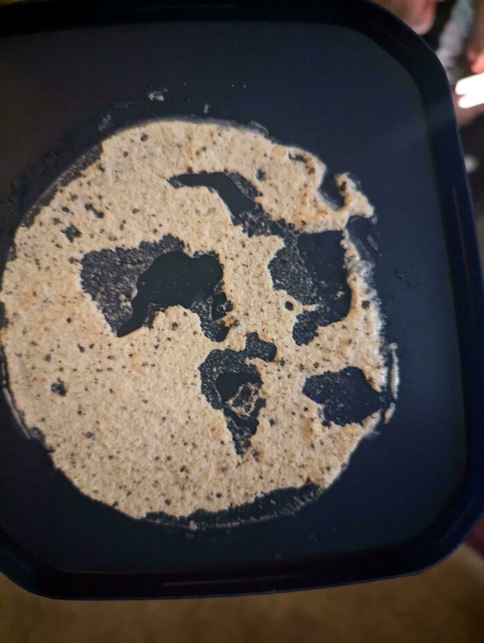 Mildly interesting pattern of a burnt tortilla resembling a world map on a pan.