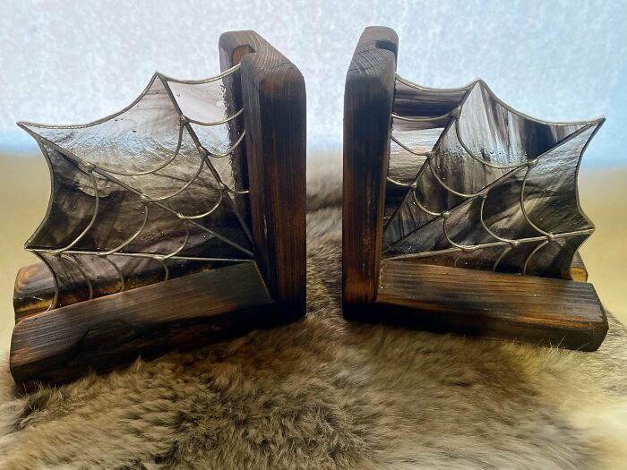 "Impressive woodworking project featuring artistic wooden bookends with web design details on a soft fur background."