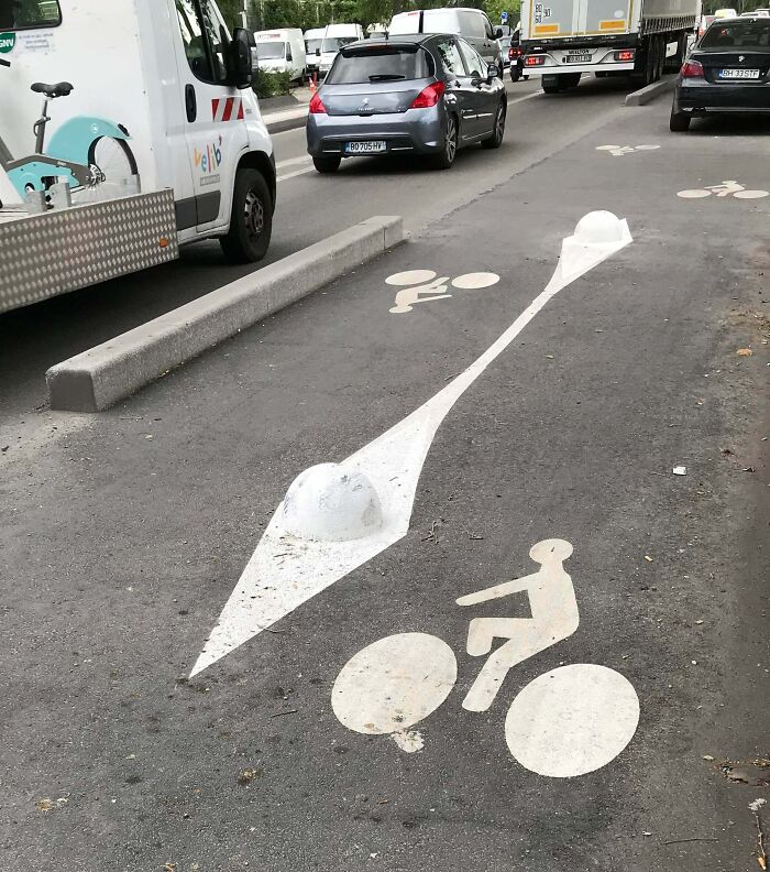 Bicycle Lane In Paris. The Two White Bumps Are Nearly Invisible Because Of The Paint Camouflaging Them