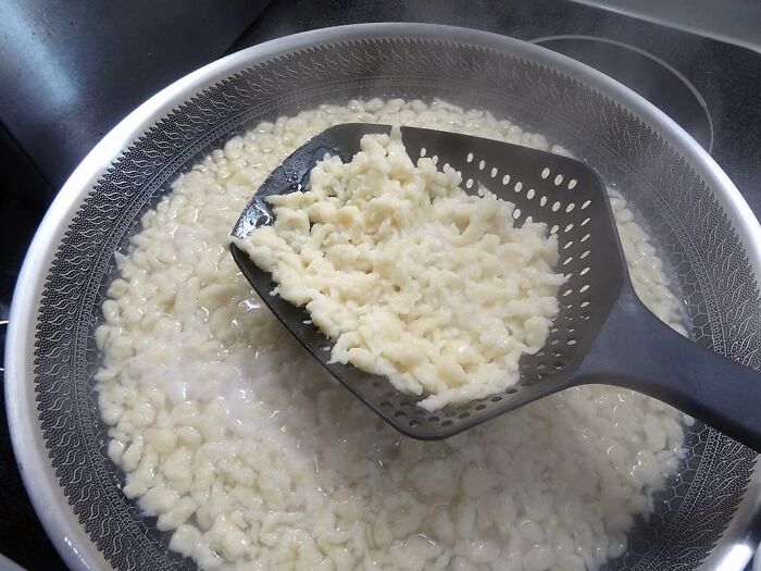 For When You're Tired Of Playing A Game Of "Dodge The Hot Water" While Trying To Drain Your Pasta, This Collander Spoon Is The Clever Utensil That Lets You Scoop, Drain, And Serve Without Scalding Yourself