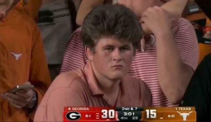 Fan with unusual hairstyle at a sports event, embodying tragic hair accidents theme.