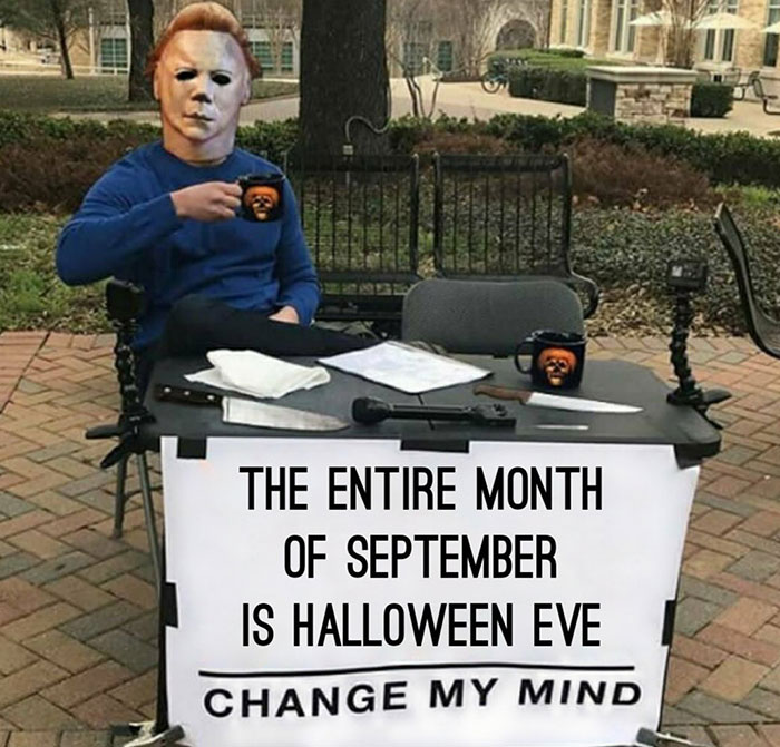 A Fall meme showing a person in a Halloween mask at a table with a sign that reads, "The entire month of September is Halloween Eve. Change my mind."