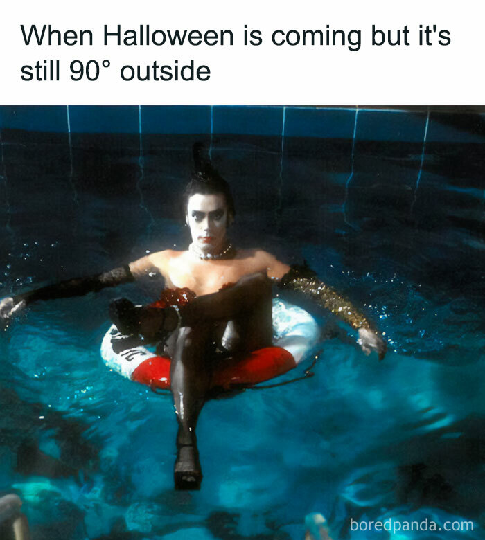 A Fall meme with a person in Halloween attire floating on an inflatable ring in a pool. The text reads, "When Halloween is coming but it's still 90° outside," highlighting the contrast between fall vibes and hot weather.