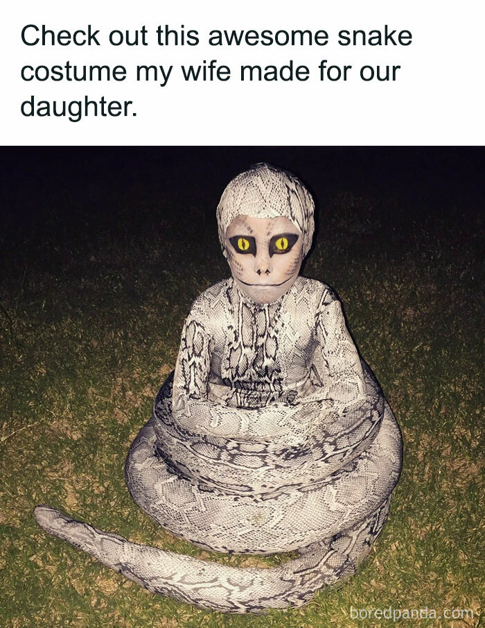 A Halloween meme featuring a child in an elaborate snake costume, with the body coiled around her and detailed snake-like face paint. The caption above reads, "Check out this awesome snake costume my wife made for our daughter," highlighting the impressive and realistic costume design.