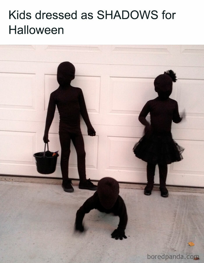 A Halloween meme featuring three children dressed entirely in black bodysuits as shadows. One child is holding a trick-or-treat bucket, another is crawling, and the third is wearing a tutu. The caption above reads, "Kids dressed as SHADOWS for Halloween," humorously highlighting their creative costumes.