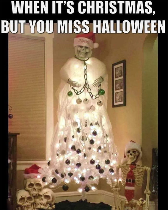 A Halloween meme featuring a Christmas tree decorated with skeletons and skulls, with the top of the tree resembling a ghost and wearing a Santa hat. The caption above reads, "When it's Christmas, but you miss Halloween," humorously showing a spooky twist on Christmas decor.