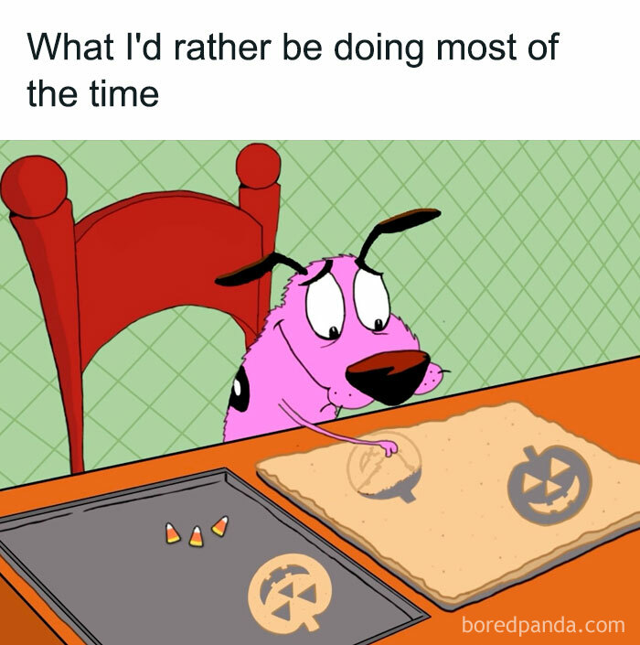  A Halloween meme featuring a pink cartoon dog at a table using a pumpkin-shaped cookie cutter to make Halloween-themed cookies. The caption reads, "What I'd rather be doing most of the time," highlighting the fun of Halloween activities.