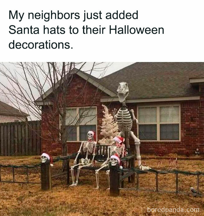 A Halloween meme featuring a yard display of skeleton decorations wearing Santa hats. The caption above reads, "My neighbors just added Santa hats to their Halloween decorations." The scene humorously blends Halloween and Christmas elements.