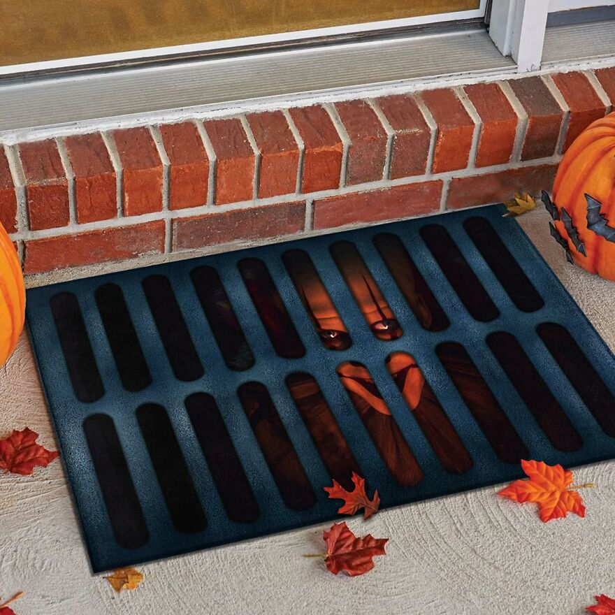 Welcome Trick-Or-Treaters And Party Guests To A World Of Terror With This Halloween Doormat, Featuring A Chilling Design Of Pennywise Peeking Out From The Sewer