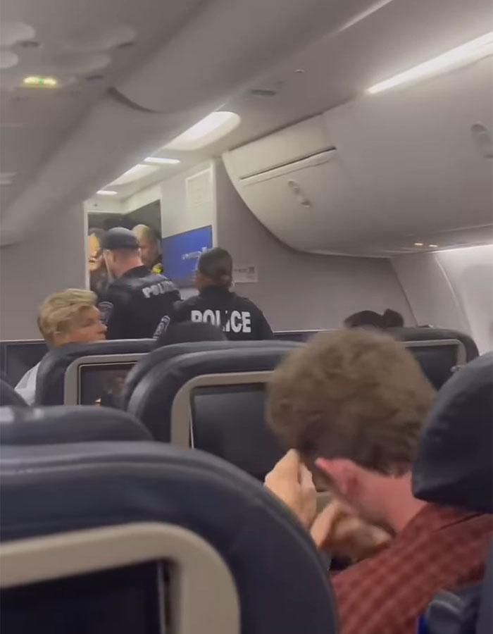 Hilarious Theme Song Accompanies Racist Woman As She’s Removed From Flight