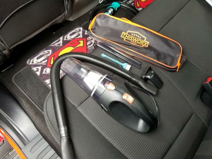 Car vacuum and cleaning tools on seat, a cheap fix for irritating messes.