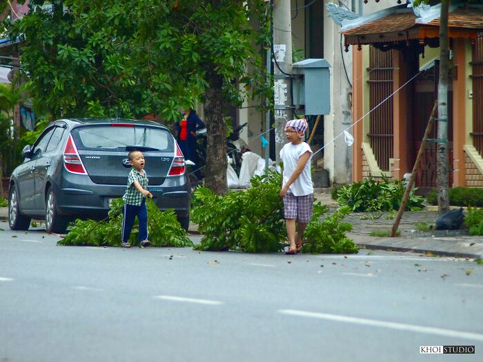 Children Are Helping Their Families Clean Up Trees After The Storm Passed