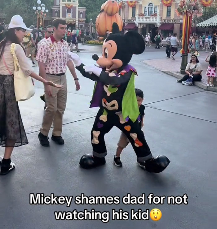 Dad’s Being Neglectful Towards Own Kid At Disneyland, Gets Unexpectedly Called Out By Mickey Mouse