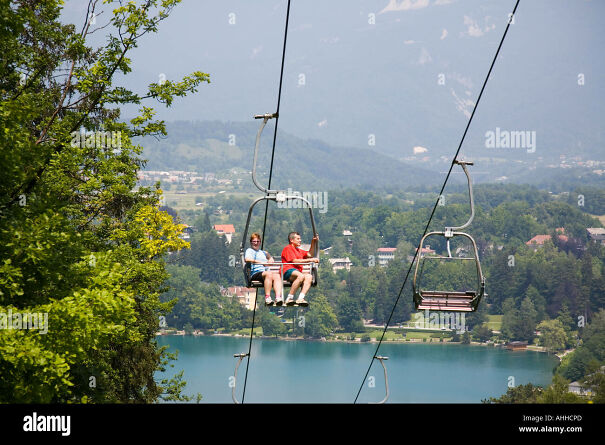 people-riding-on-chair-lift-on-straza-ski-slope-above-lake-bled-in-AHHCPD.jpg