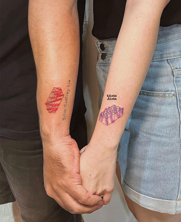  "A small tattoo idea for couples featuring matching LEGO bricks in red and purple on forearms, symbolizing connection and creativity."