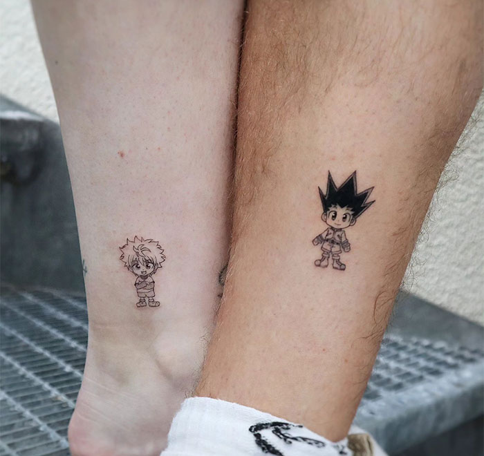 "A small tattoo idea featuring matching chibi characters from an anime, one on each person's ankle, symbolizing a shared love for the series."