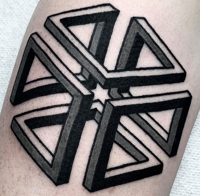 A small tattoo idea featuring an intricate geometric design with interconnected, three-dimensional triangles forming a star shape, shaded for depth.