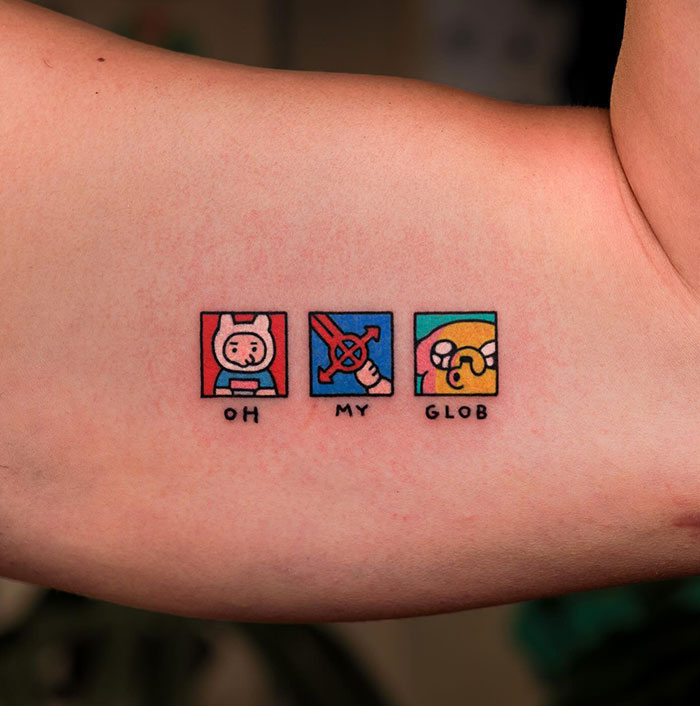 A small tattoo idea featuring three vibrant cartoon-style squares, each with a playful character and the phrase "Oh My Glob" below, adding a fun and nostalgic touch for animation fans.