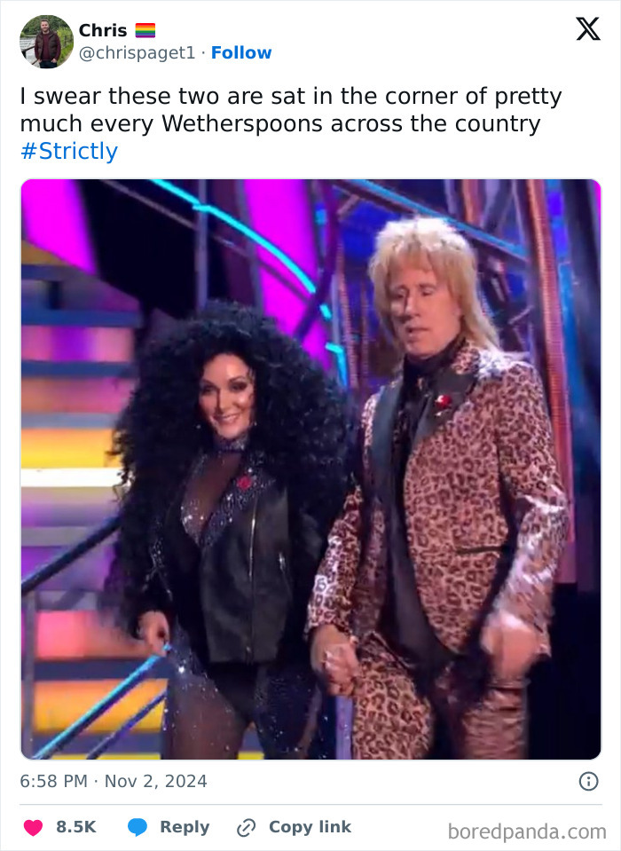 Two people in flamboyant costumes on stage, featured in a funny tweet online, November.