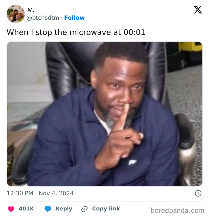 Person humorously gesturing silence in an online funny tweet, referencing stopping the microwave at 00:01.