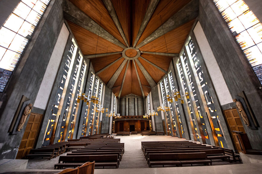 Abandoned sacred place in Europe with wooden ceiling and empty pews.