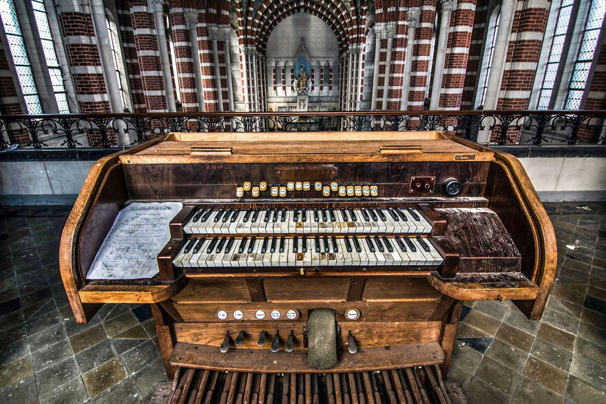 Abandoned sacred place in Europe with a weathered organ in a deserted church interior.