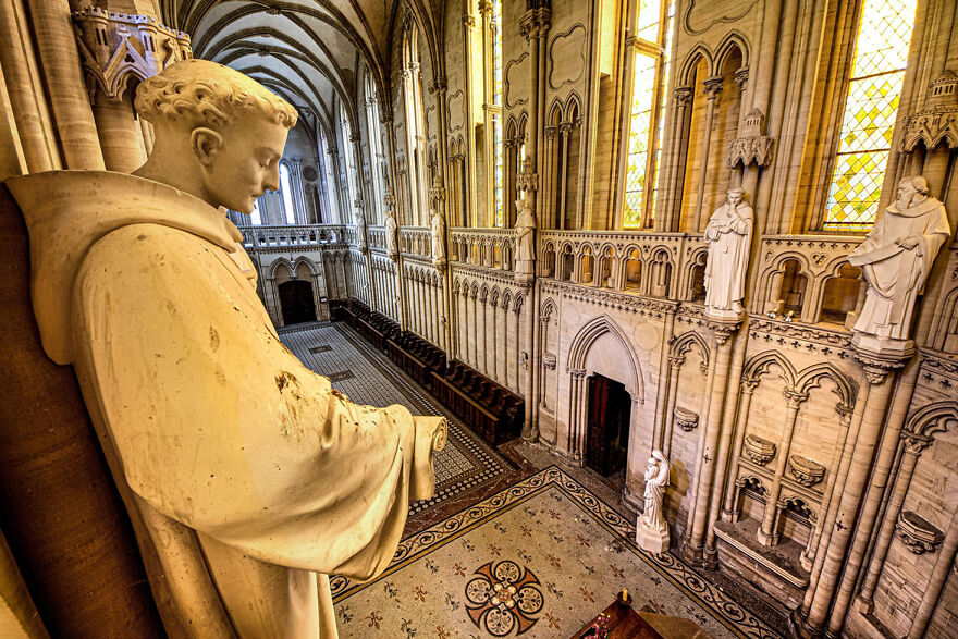 Stunning interior view of an abandoned sacred European place, featuring ornate architecture and statues.