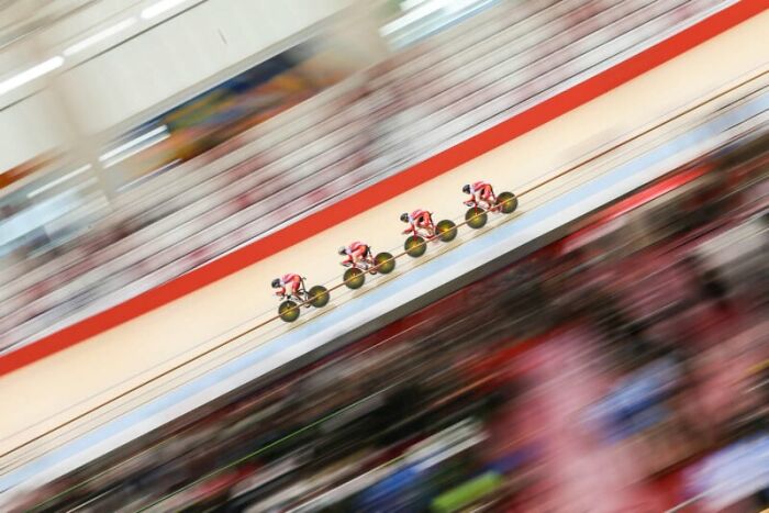 Cyclists in motion blur during a race, capturing breathtaking photography and sustainability themes at HIPA 2024.