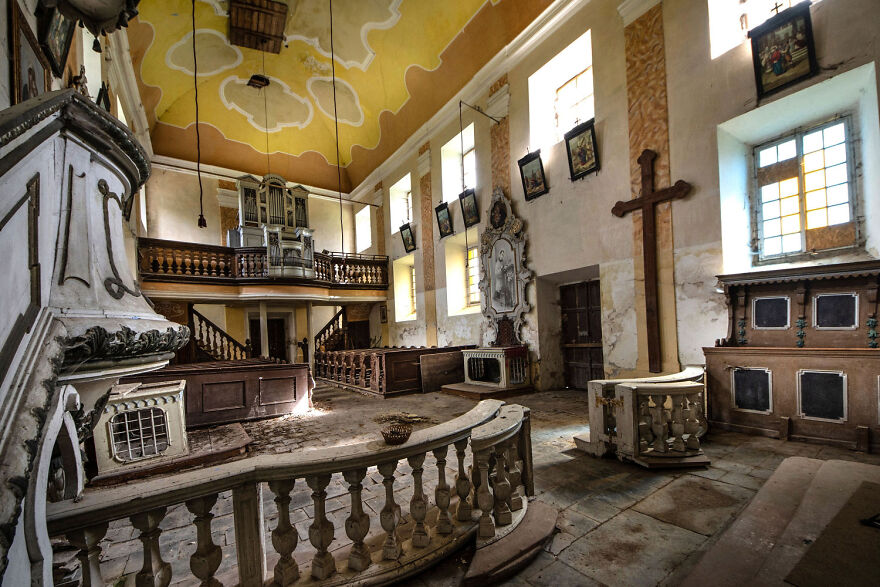 Abandoned sacred place in Europe, featuring a grand interior with faded elegance and intricate architectural details.