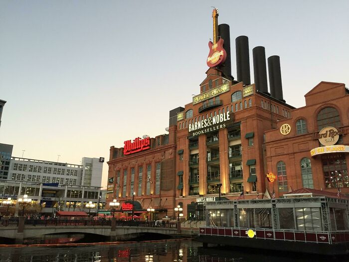 Historic power plant building conversion featuring Barnes & Noble and Hard Rock Cafe against a dusk sky.