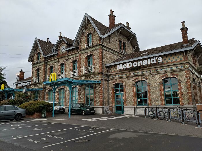 McDonald's in a charming historic building conversion, showcasing unique architecture with brick and blue accents.