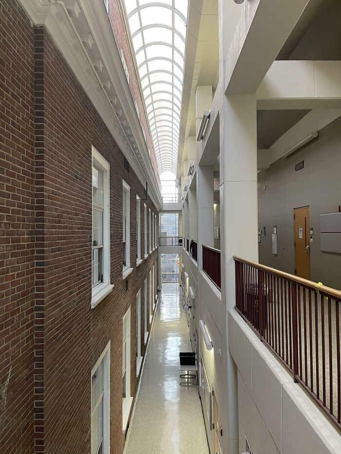 Interior view of a beautifully converted building with a high arched ceiling and exposed brick walls.