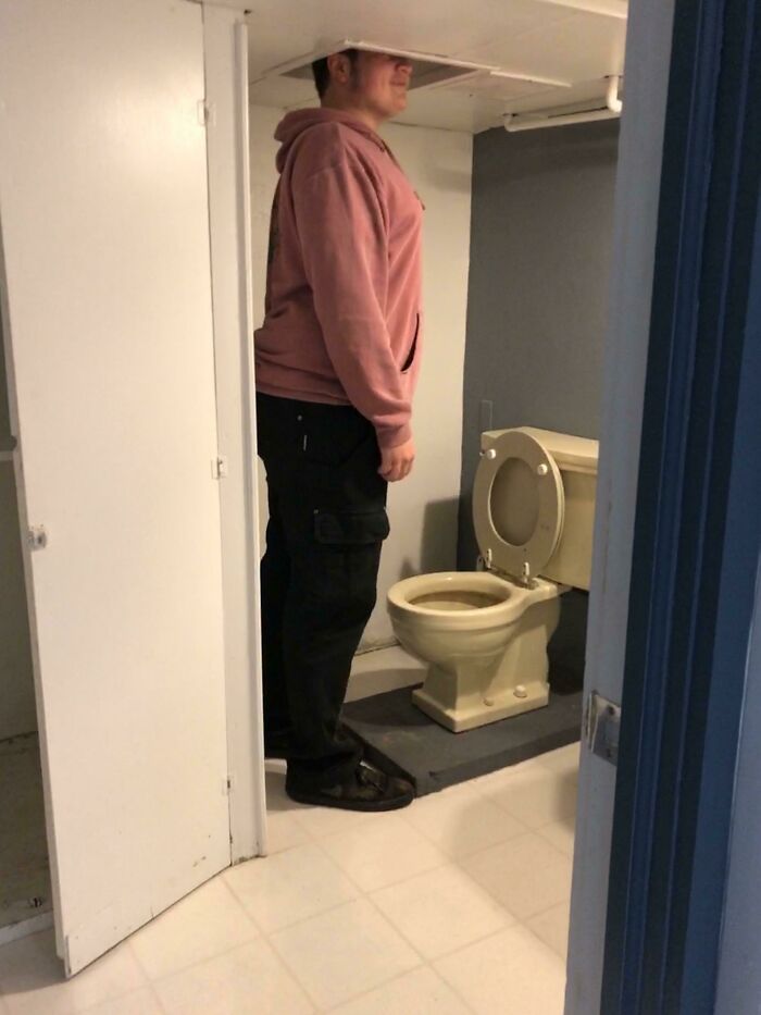 This Bathroom In My Dads New House. I’m 6’1”. The Room Is So Short They Had To Cut Holes In The Ceiling Over The Toilet And Sink So You Can Stand Up