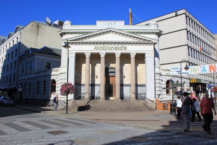 A McDonald's located in a historic building with columns, exemplifying unique building conversions.