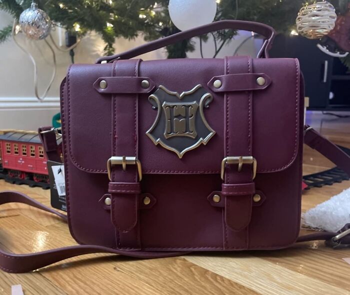 Add A Touch Of Hogwarts Charm To Your Everyday With The Maroon Handbag With Hogwarts Hardware, A Stylish Way To Show Off Your Wizarding Flair