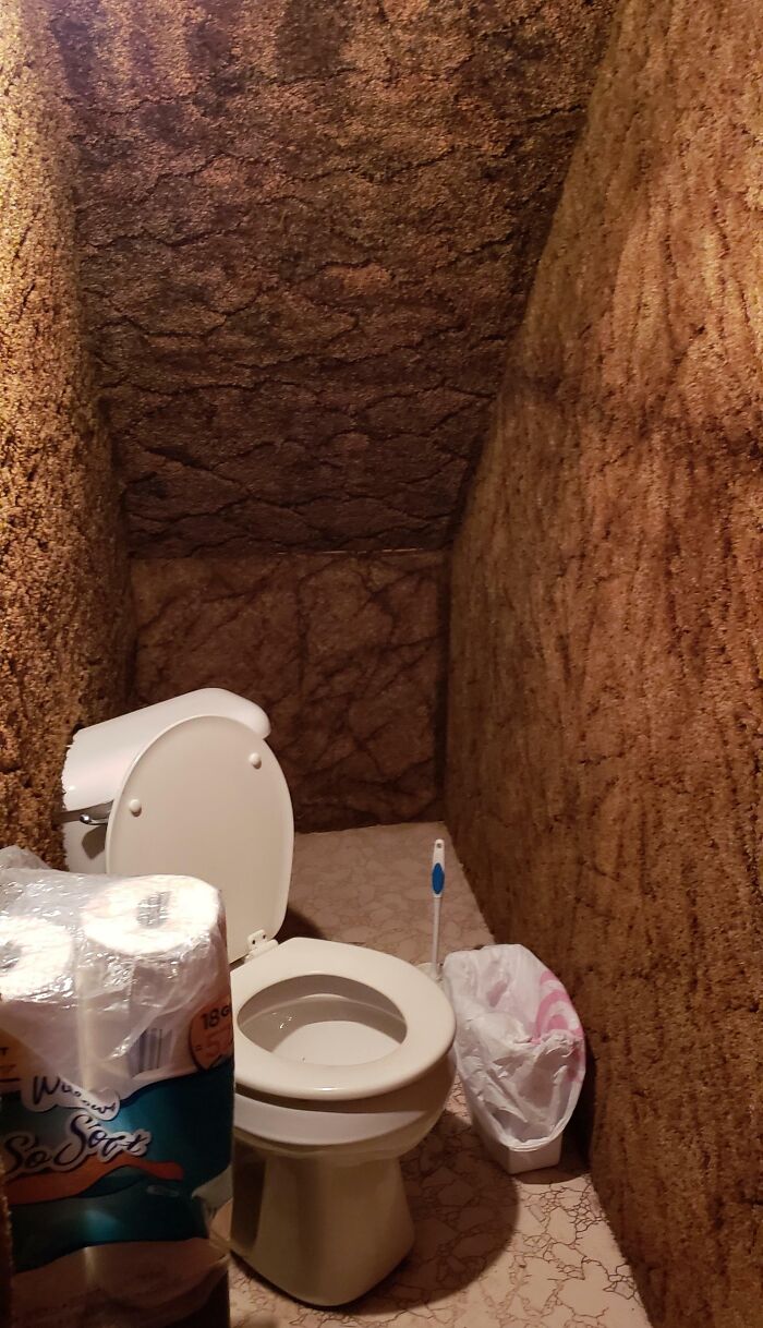 My Friend's Under-The-Stairs "Bathroom" Where The Toilet Is Diagonal And Partially Installed Into The Carpeted Wall