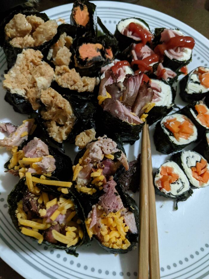 A plate of sushi with unusual ingredients, humorously showcasing infuriating boyfriends' cooking attempts.