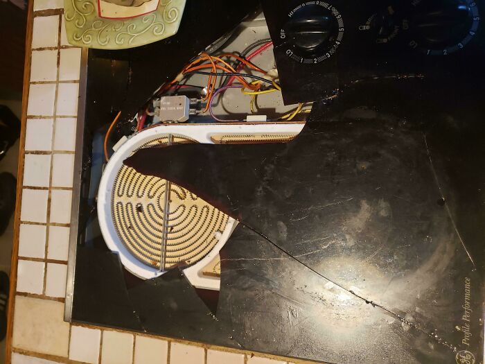 Broken stovetop with exposed wiring, illustrating a frustrating household mishap by boyfriends or husbands.