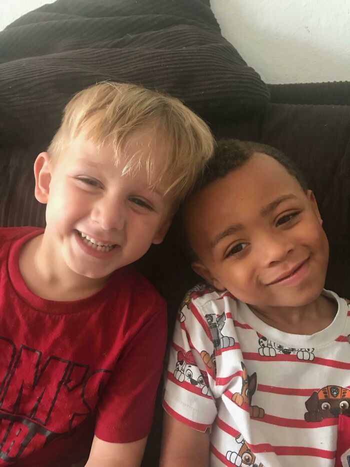 Two young boys smiling together, representing wholesome adoption stories.