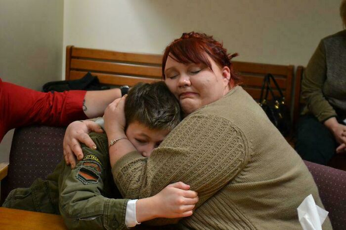 A heartwarming moment of a mother hugging her adopted child, showcasing a touching adoption story.