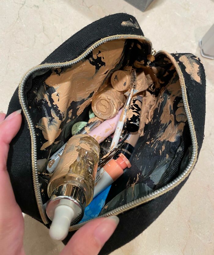 Makeup bag covered in foundation mess, highlighting infuriating boyfriends and husbands' mishaps.