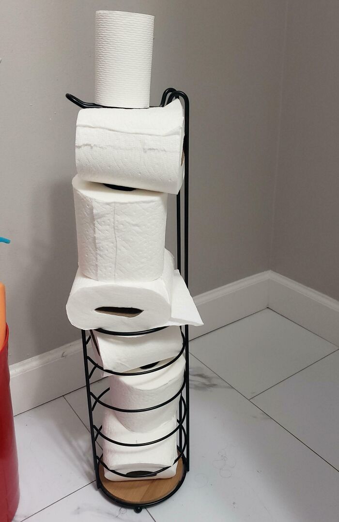 Toilet paper rolls messily stacked in a holder, highlighting infuriating habits of boyfriends and husbands.