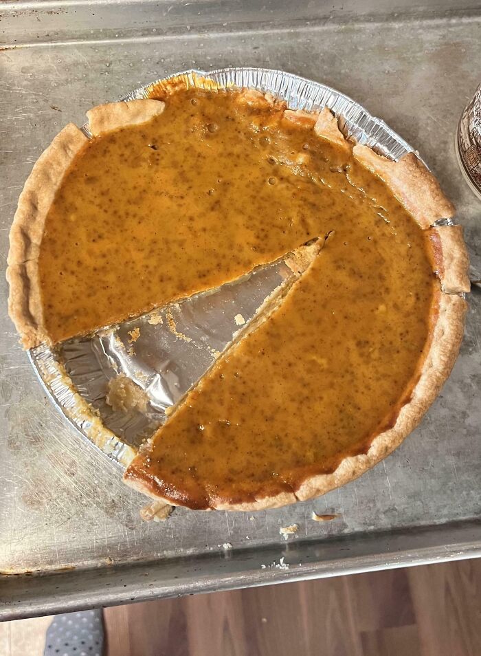 Pumpkin pie with a single, uneven slice missing, infuriating husband moment captured.