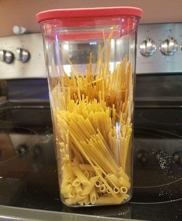 Mixed pasta types in a jar showcase infuriating organization in the kitchen, causing annoyance.