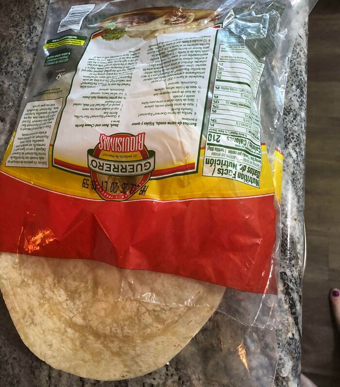 Upside-down tortilla package opened and left on a countertop, showcasing infuriating habits of boyfriends and husbands.