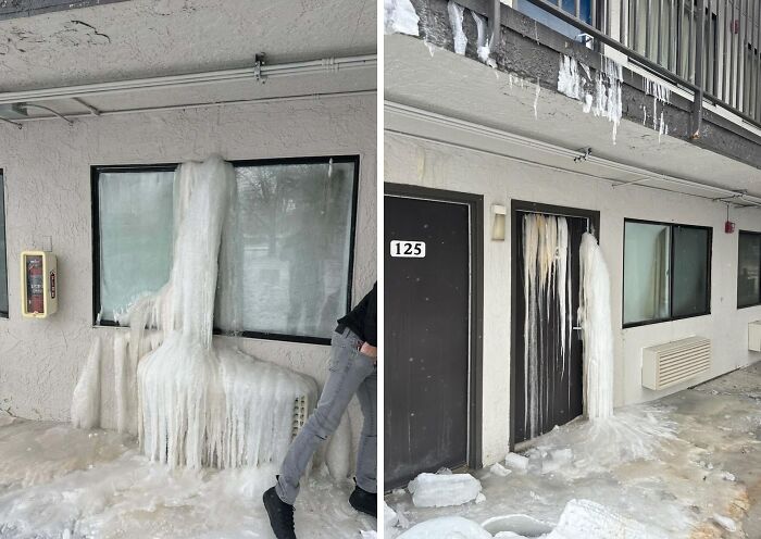 Ice-covered building facade with large icicles hanging from the roof during a cold winter.