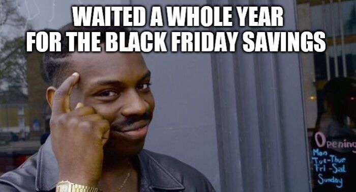 Smiling man in a leather jacket pointing at his head with text about Black Friday savings, showcasing a funny Black Friday meme.