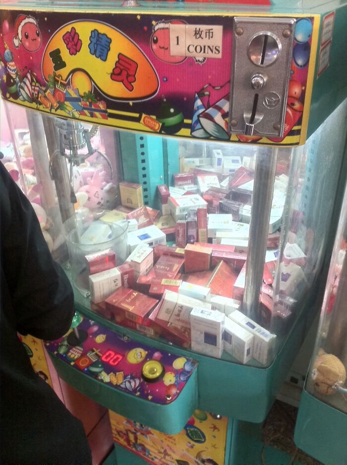 A Claw Machine Game Full Of Cigarettes At A Theme Park In Beijing