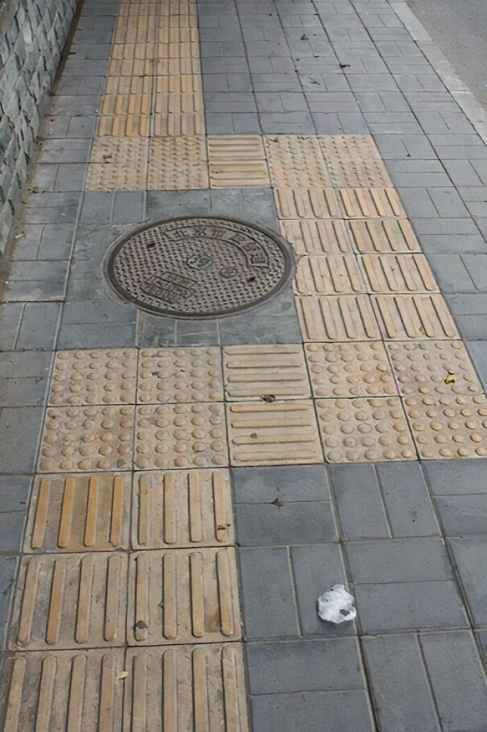 In Beijing, The Markings For Blind People Can Exist Purely To Guide Them Around A Manhole, As Stepping On One Is Seen As Very Bad Luck Here