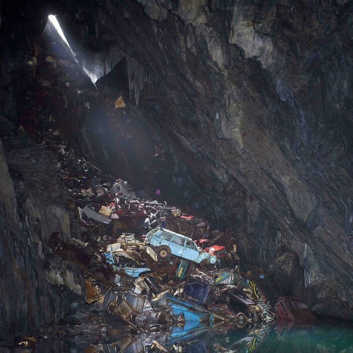 Cars in a cave pile-up under soft light, resembling a Renaissance painting ambiance.